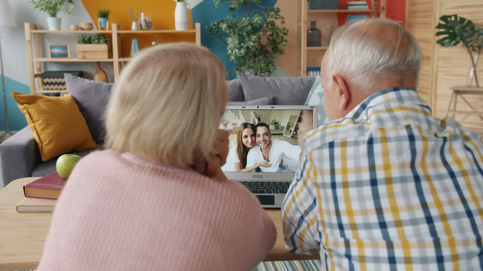 Elderly couple at home on a video call with family