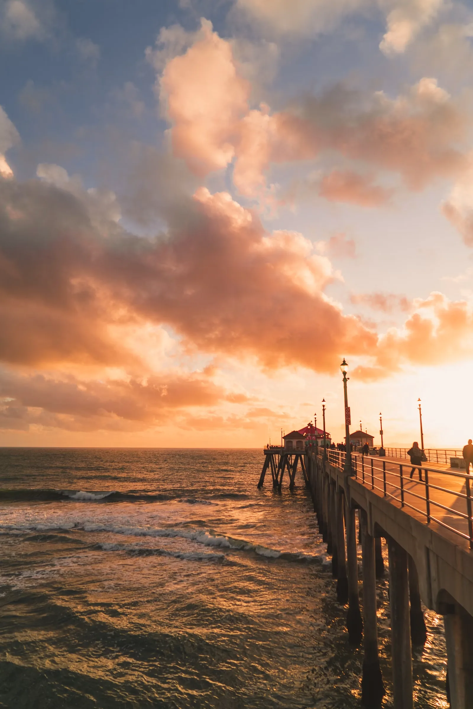 Wooden pier stretching over the Pacific at sunset in Orange County